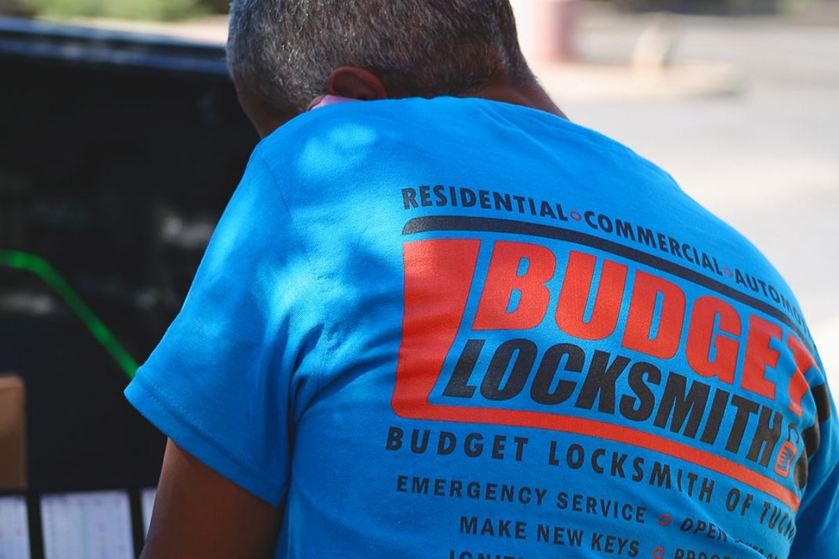 Mobile locksmith programming a car key at a vehicle in Tucson, AZ