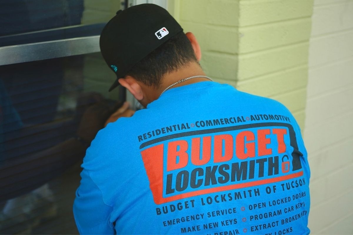 Locksmith servicing commercial door hardware at a Tucson business